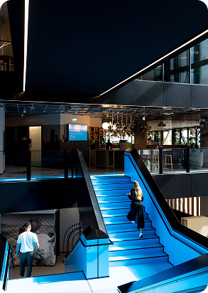 Photo inside the 2degrees office of a staff member walking up the stairs